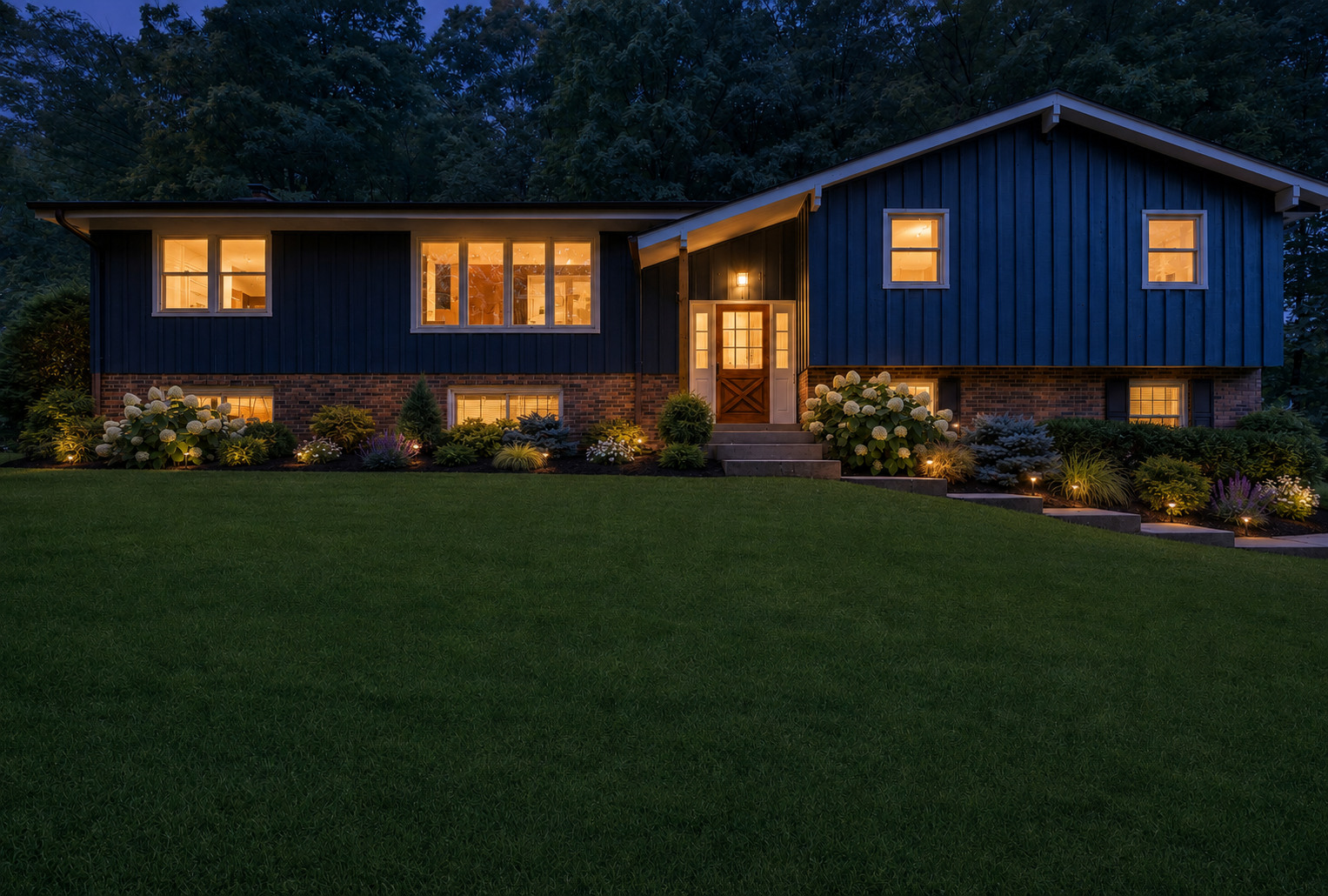 The design after dark: Warm architectural and path lighting adds depth, safety, and curb appeal.